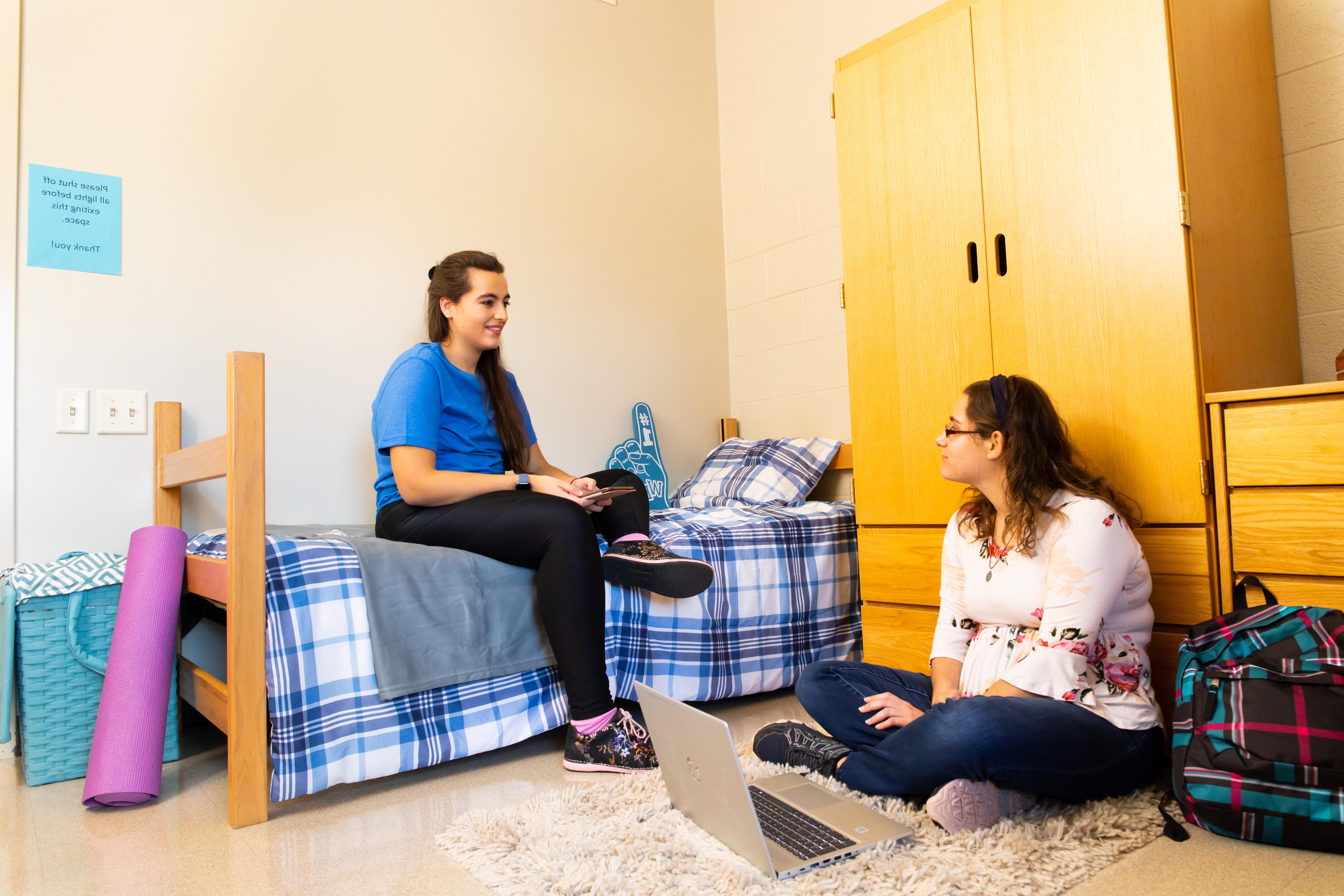 Two students talking in residence hall dorm room